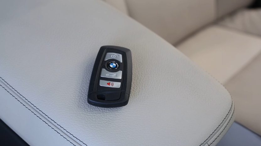 BMW key fob resting on a car seat during a BMW key replacement process
