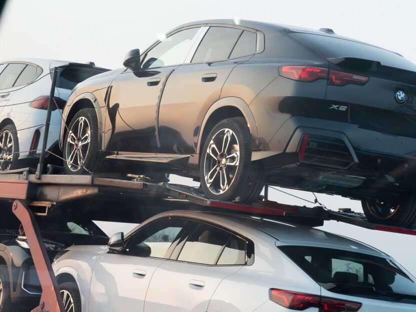 BMW vehicles loaded on a car transport trailer secured for shipping